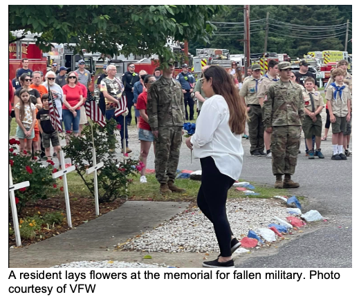 Residents lay flowers at Memorial at VFW